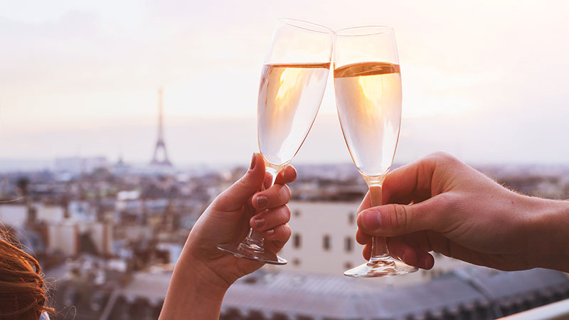 Two glasses of champagne or wine, couple in Paris