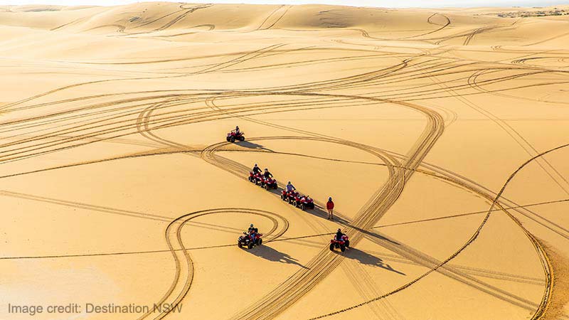 Small group enjoying an Aboriginal cultural tour on quad bikes with Sand Dune Adventures, Port Stephens.