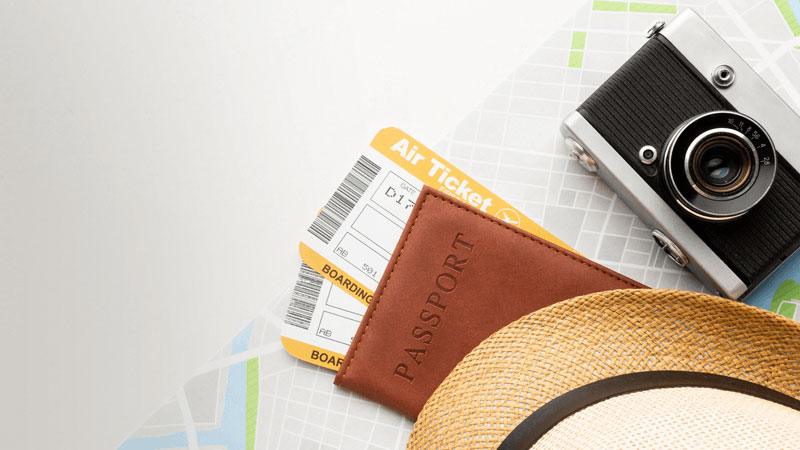 Passport with tickets on the plane and a straw hat