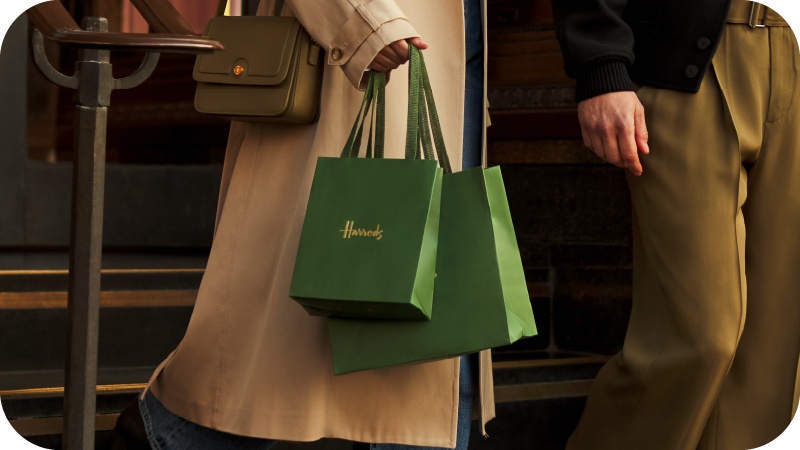 A woman carrying Harrods branded bags